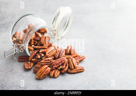 Peeled pecan nuts in jar on the kitchen table. Stock Photo