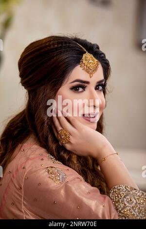 Indian bride dressed in traditional wedding clothes Stock Photo