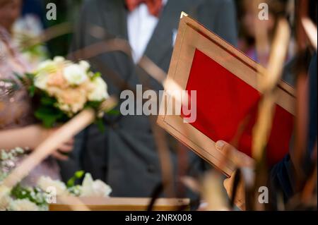 mayor holding red official decorative folder for documents on wedding Stock Photo