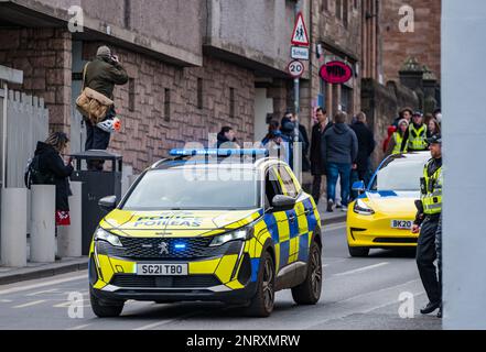 Photographer taking photo of march on Royal Mile with police car, Edinburgh, Scotland, UK Stock Photo