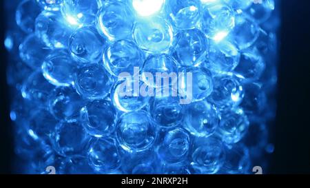 Water colored, blue gel balls. Super macro bubbles slow motion. Background with hydrogel balls with glitter. The concept of cosmetology. Luminous, shi Stock Photo