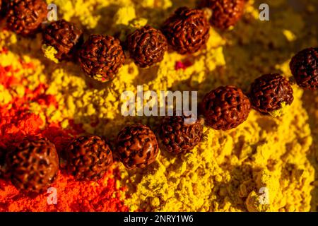 Colorful traditional holi powder on the table with wooden prayers indian beads. Happy holi. Concept Indian color festival called Holi. Organic Gulal d Stock Photo