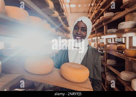 Arab investor in a warehouse of the cheese production industry Stock Photo