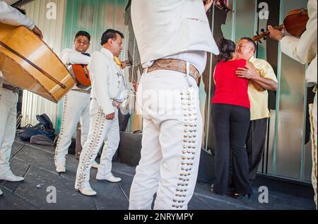 Mariachis singing a couple, Plaza Garibaldi, Mexico City, Mexico Stock Photo