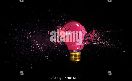 breaking of a red bulb on a black background. high speed photography Stock Photo