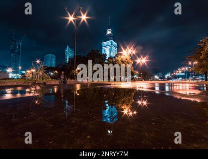 night cityscape with reflections in the puddle Stock Photo