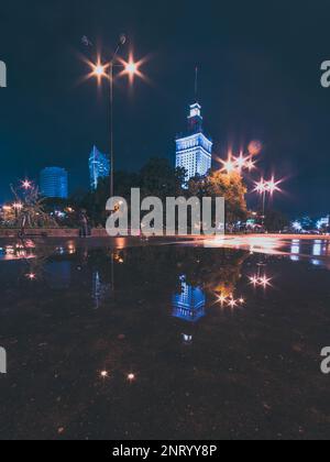 night cityscape with reflections in the puddle Stock Photo