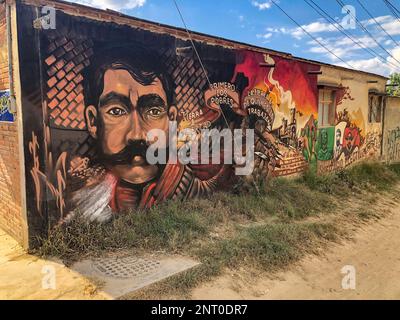 Political protest mural with a portrait of Mexican revolutionary Emiliano Zapata on a wall in the historic city of Oaxaca, Mexico. Stock Photo