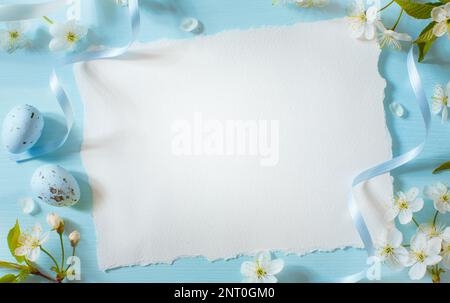 Creative easter flat lay design with white paper blank and spring flowers Stock Photo
