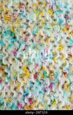 Colorful light hand made crochet or knitting textile fabric texture. Close up macro background. Stock Photo