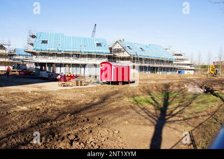 Terraced houses under construction with two construction workers on the roof in Nijmegen, Netherlands Stock Photo