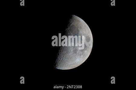 The first quarter Moon phase on 27 February 2023, when half is sunlit and half in shadow. Stock Photo