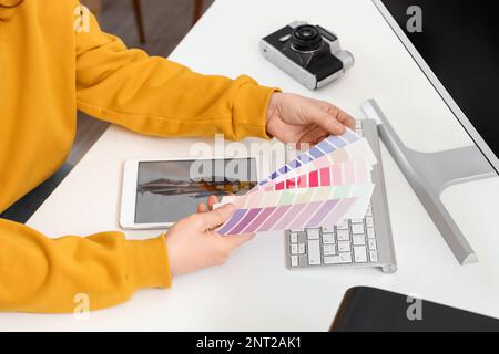 Female tailor with color palettes at table, closeup Stock Photo