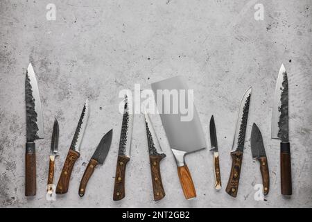Different kinds of butcher's knives forged by blacksmith Stock Photo