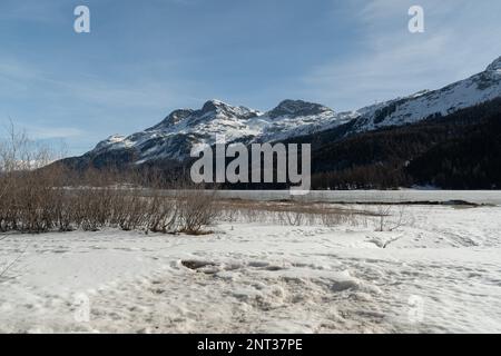 Silvaplana, Switzerland, February 21, 2023 Stunning winter landscape scenery with a frozen lake of Silvaplana Stock Photo