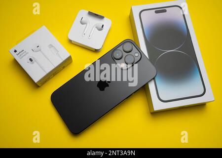 New iPhone 14 pro max and Apple Earpods, Airpods white earphones in an open  box. Isolated colorful background Stock Photo - Alamy