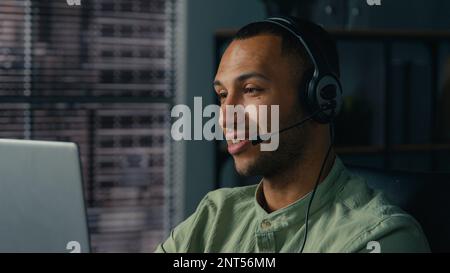African american man manager call center worker communicate with client using headset young businessman salesman advisor in headphones consulting Stock Photo