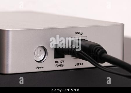 View of the hard drive from the side connected via the USB port. Close up. Stock Photo