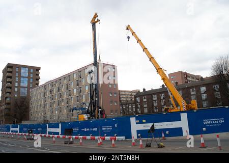 Euston, London, UK. 27th February, 2023. HS2 Ltd are doing vast amounts of construction for the new High Speed Rail 2 London Euston railway station terminus and London Underground interchange. HS2 started utility diversions in the Euston Road last week which is now slowing down traffic. Residents living in the Euston area are having to endure HS2 noise, dust and disruption that one resident  described today as 'hell on earth with no end in sight'. Credit: Maureen McLean/Alamy Live News Stock Photo