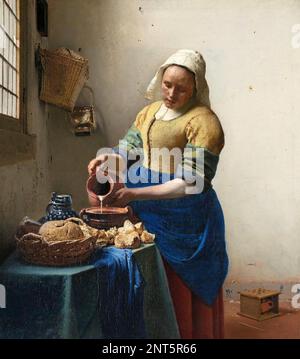 JOHANNES VERMEER (1632-1675) Dutch painter. His painting The Milkmaid about 1658 now in the  Rijksmuseum, Amsterdam Stock Photo