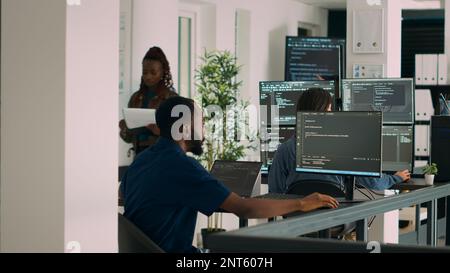 Database programer working on html script code to develop program app server with new use rinterface. Web developer typing on keyboard, computing big data on terminal window in office. Stock Photo