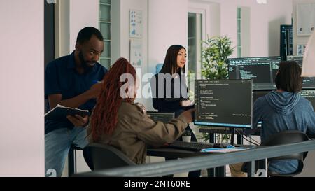 African american team of cloud programers talking about programming compiling code, working on new user interface development. Coders doing teamwork to develop server algorithms. Stock Photo