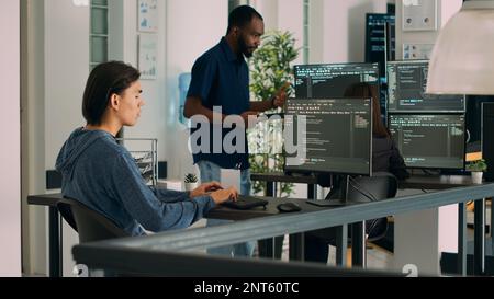 Database programer developing source code and cloud computing in it development agency. Asian app programmer typing on keyboard to create artificial intelligence script. Tripod shot. Stock Photo