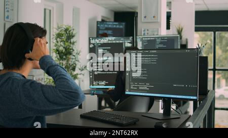 Software developer programming source code algorithm on computer, typing sever data in agency office. Database programer working on new user interface with online system to create algorithm. Stock Photo
