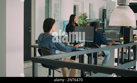 Asian script programer working with database information to use new interface code. Software developer writing html language data, planning security app in it development agency office. Stock Photo
