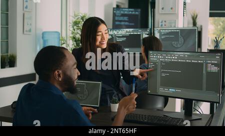Team of diverse programers doing highfive gesture after coding database, celebrating cloud computing achievement. Successful firewall server development with it software language. Stock Photo