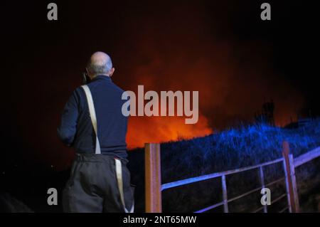 Bantry, West Cork, Ireland. 27th February, 2023. The gorse fire season has recently started in West Cork, pictured below: Seskin Hill in Bantry is in massive flames. Credit: Karlis Dzjamko/ Alamy Live News Stock Photo