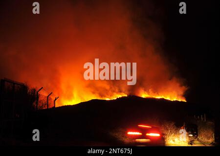 Bantry, West Cork, Ireland. 27th February, 2023. The gorse fire season has recently started in West Cork, pictured below: Seskin Hill in Bantry is in massive flames. Credit: Karlis Dzjamko/ Alamy Live News Stock Photo