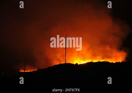 Bantry, West Cork, Ireland. 27th February, 2023. The gorse fire season has recently started in West Cork, pictured below: Seskin Hill in Bantry is in massive flames. Credit: Karlis Dzjamko/ Alamy Live News Stock Photo