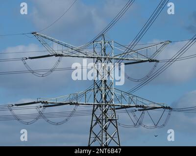 high voltage power electicity lines mast tower closeup in the port area of Rotterdam the Netherlands Stock Photo