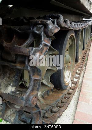 Wheels and suspension of rare tracked war machine with dirt and rust on a tracks Stock Photo