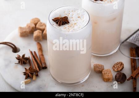 Chai latte in glasses with warm winter spices, foam dusted with nutmeg Stock Photo