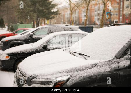 Snow on car during a cold snow storm in the city blizzard in the northeast during winter holiday season Stock Photo