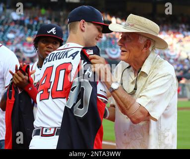 Former Atlanta Braves pitcher and Baseball Hall of Fame member Phil Niekro  presents Braves' Mike Soroka with his All-Star jersey before the team's  baseball game against the Philadelphia Phillies on Tuesday, July