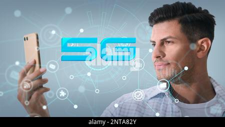 Man using smartphone with 5G network system against light blue background. Banner design Stock Photo