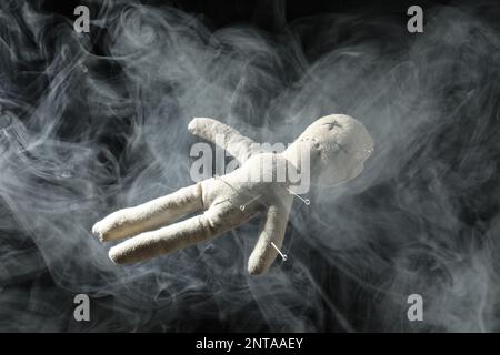 Voodoo doll with pins and smoke on dark background Stock Photo - Alamy