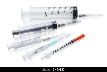 Different disposable syringes with needles on white background Stock Photo