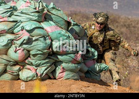 Isiolo, Kenya. 13th Feb, 2023. U.S. Army Sgt. Ricardo De Los Santos, assigned to Chosen Company, 2nd Battalion, 503rd Parachute Infantry Regiment, 173rd Airborne Brigade, throws an M67 fragmentation grenade down a bunker during exercise Justified Accord 23 (JA 23) in Isiolo, Kenya, February.13, 2023. JA 23 is U.S. Africa Command's largest exercise in East Africa. Led by U.S. Army Southern European Task Force, Africa (SETAF-AF), this multinational exercise brings together more than 20 countries from 3 continents to increase partner readiness for peacekeeping missions, crisis response and Stock Photo