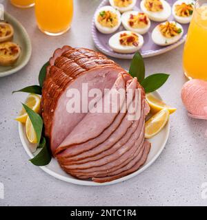Traditional Easter ham on the table served with Easter brunch Stock Photo