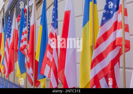 WARSAW, POLAND – February 21, 2023: Ukrainian, American, and Polish flags are seen prior to a speech by President Joe Biden at Warsaw's Royal Castle. Stock Photo
