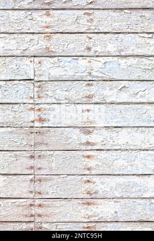 Close-up on an old white painted wooden board background with rusty nails. Stock Photo