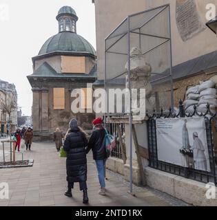 LVIV, UKRAINE – February 23, 2023: Pedestrians are seen in Lviv. Stock Photo