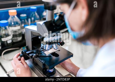 Female Scientist Using Microscopy in Laboratory closeup Stock Photo