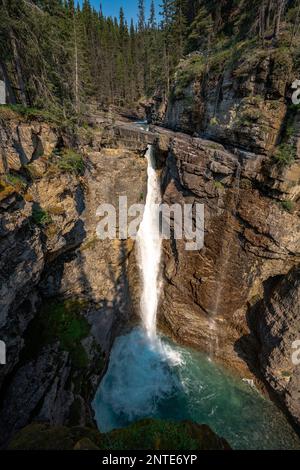 Upper waterfall from above view along hiking trail in Johnston canyon on a sunny summer day. Stock Photo