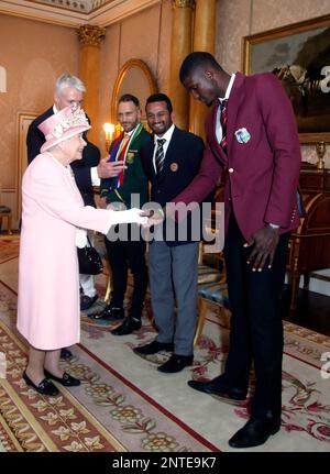 Britain's Queen Elizabeth meets West Indies cricket captain Jason Holder, right, South Africa cricket captain Francois du Plessis, left, and Sri Lanka captain Dimuth Karunaratne during a Royal Garden Party at Buckingham Palace in London, Wednesday, May 29, 2019. (Yui Mok/Pool photo via AP)