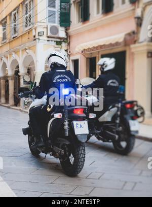 Greek police squad formation on duty riding bike and motorcycle and maintain public order in the streets of Kerkyra, Corfu, Greece, group of policemen Stock Photo